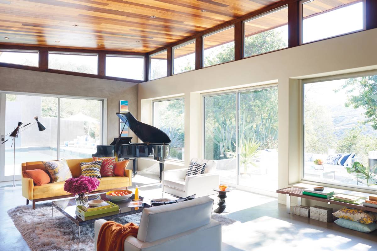 A colorful living room with expansive windows perfect for Hunter Douglas Duette® Cellular Shades at Window Fashions of Northern California near Fairfield and Fremont, CA
