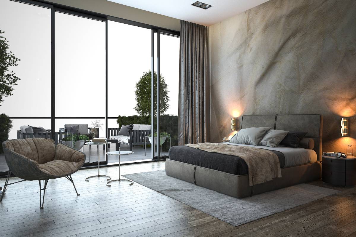 A modern bedroom with a chair, tables, and a sliding glass door at Window Fashions of Northern California near Fairfield and Fremont, CA