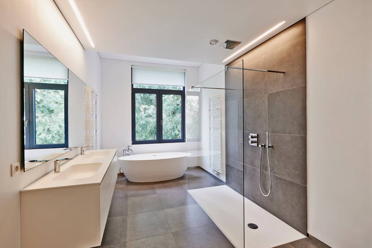 A luxury modern bathroom with a shade-style window treatment at Window Fashions of Northern California near Fairfield, California (CA)